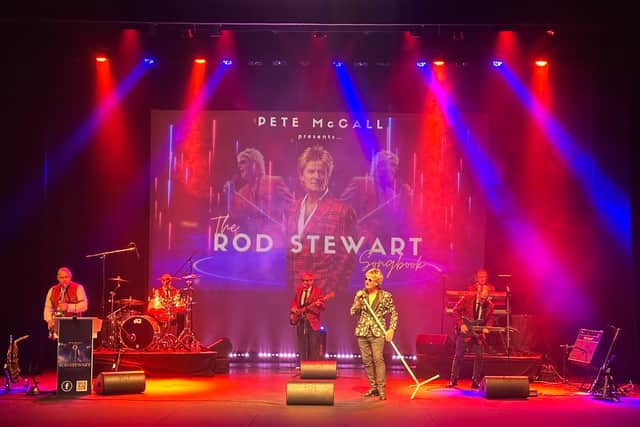 The Rod Stewart Songbook performing on stage with red and blue lighting.