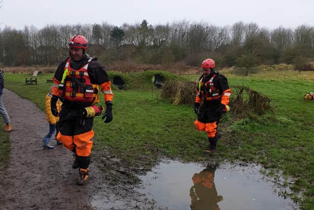 Firefighters arrive for the rescue of cocker spaniel Artie from an island at a lake at Melton Country ParkPHOTO WENDY GRAY EMN-191230-135548001
