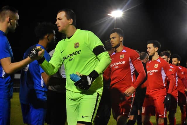 Melton Town captain Rob Peet leads his side out for the pre-match meet and greet EMN-200129-111837002