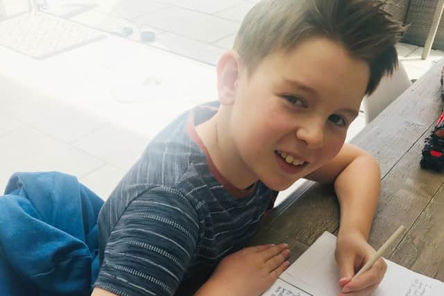 Melton schoolboy Jonasz Bettinson writes his book which has raised nearly £1,000 for the NHS EMN-200625-162432001