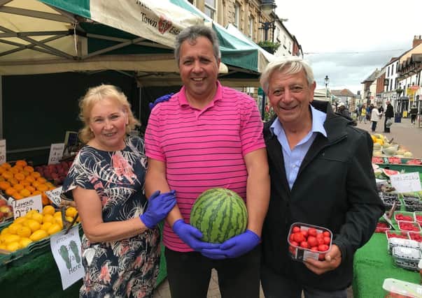 Mark Shaw and his parents, Mary and Pete, pictured on their fruit and veg stall on their last day of trading on Melton street market on Saturday EMN-200629-100349001