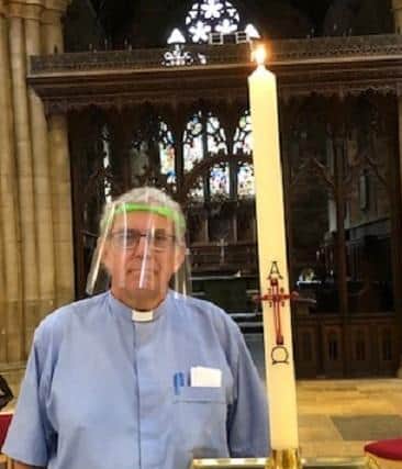 Rev Kevin Ashby pictured in PPE as St Mary's Church. Melton, reopened for private prayer EMN-200713-174200001