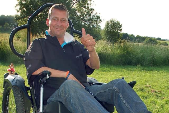 Stewart Sparling testing out the life-changing specialised wheelchair he got in 2013 PHOTO: Tim Williams EMN-200408-150259001