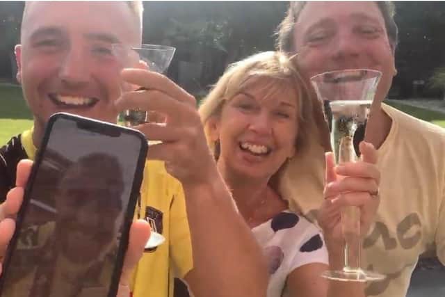 George Thomson Facetiming his parents as they celebrate after the final whistle on Sunday EMN-200508-145105001