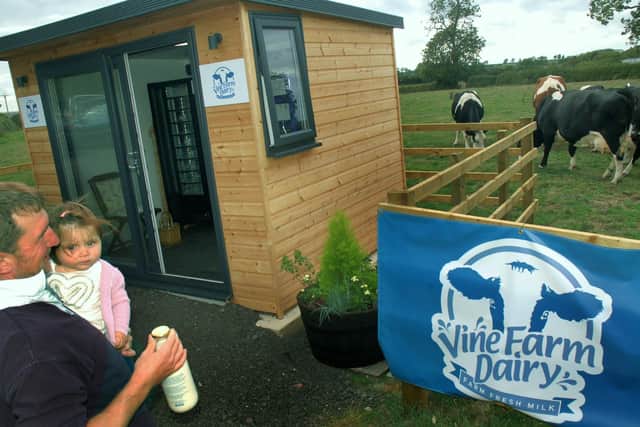 The milk vending machine at Vine Farm, Great Dalby, and the dairy herd in the background EMN-200608-154417001