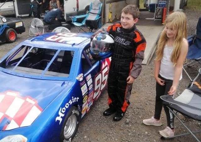 Oscar Dustan (9) with his racing car and sister Anna-May EMN-200814-162651001