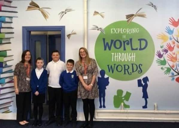 Headteacher Hayley Cheeseman (right) with pupils and a colleague at The Grove Primary School, Melton, showing off one of the exciting new wall wraps EMN-200209-132742001