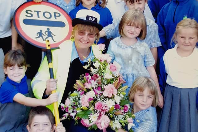 Former Melton lollipop lady, Margaret Hendey, who has passed away aged 78, pictured with The Grove School pupils on her retirement day in 2004 EMN-200109-180534001