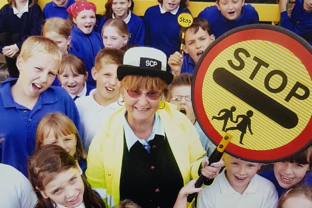 Former Melton lollipop lady, Margaret Hendey, who has passed away aged 78, pictured with The Grove School pupils on her retirement day in 2004 EMN-200109-180557001
