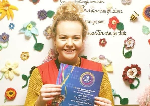 Leah Reek proudly shows off her certificate after she was officially recognised for her voluntary work for LOROS EMN-200309-172335001
