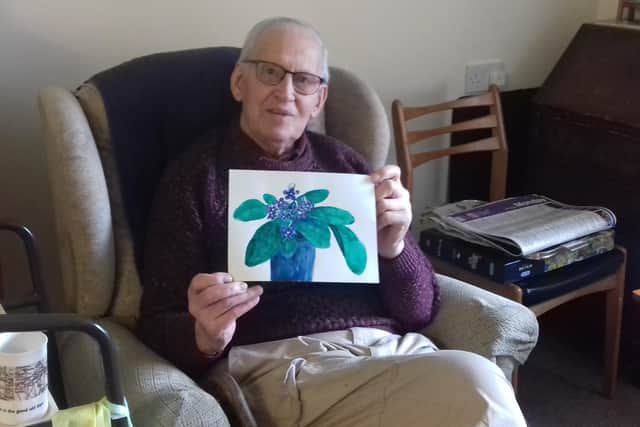 Leslie Posnett (100) with one of the paintings he has submitted for a virtual lockdown time capsule EMN-200409-115549001