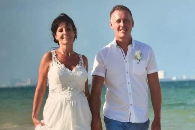 Caroline Roberts and her husband of 28 years, Chris, pictured on holiday EMN-200916-134235001