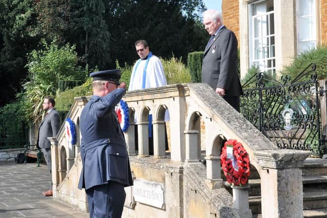 A wreath is laid on behalf of the RAF Air Cadets (1279 Squadron) by Flying Officer McHale in a ceremony to commemorate the 80th anniversary of Battle of Britain Day at the town's Memorial Gardens EMN-200922-100056001