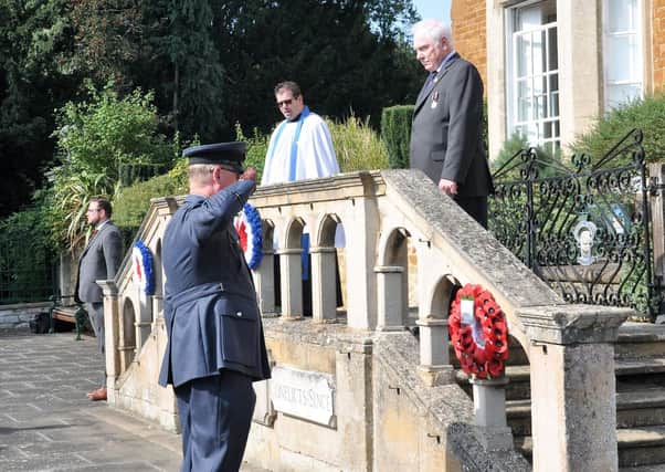 A wreath is laid on behalf of the RAF Air Cadets (1279 Squadron) by Flying Officer McHale in a ceremony to commemorate the 80th anniversary of Battle of Britain Day at the town's Memorial Gardens EMN-200922-100056001