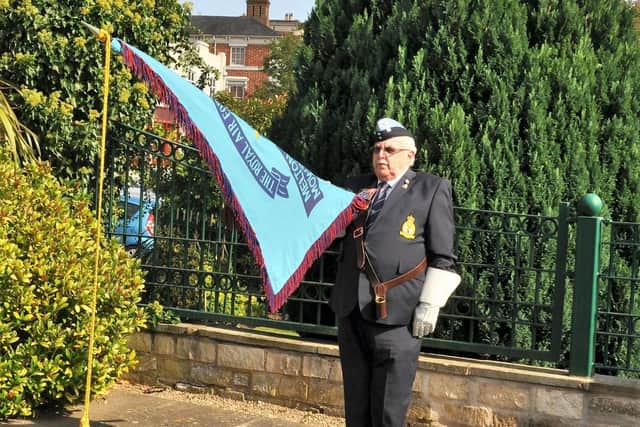The RAFA Melton Mowbray branch standard is carried by Phil Taylor at a ceremony to commemorate the 80th anniversary of Battle of Britain Day at the town's Memorial Gardens EMN-200922-100031001