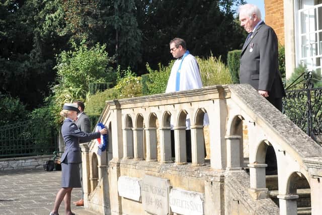 A wreath is laid on behalf of the Melton-based Defence Animal Training Regiment (RAF Section) by Cpl Sarah Holmes, in a ceremony to commemorate the 80th anniversary of Battle of Britain Day at the town's Memorial Gardens EMN-200922-100121001