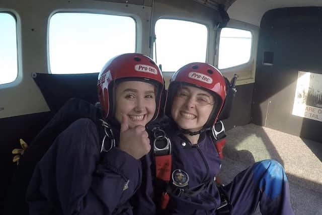 Twins Jessica Brown (right) and her twin Olivia in the plane before doing their first solo charity parachute jumps EMN-200310-114353001
