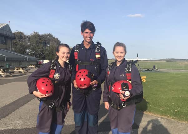 Jessica and Olivia Brown with Samuel Page before their solo charity parachute jumps EMN-200310-114342001