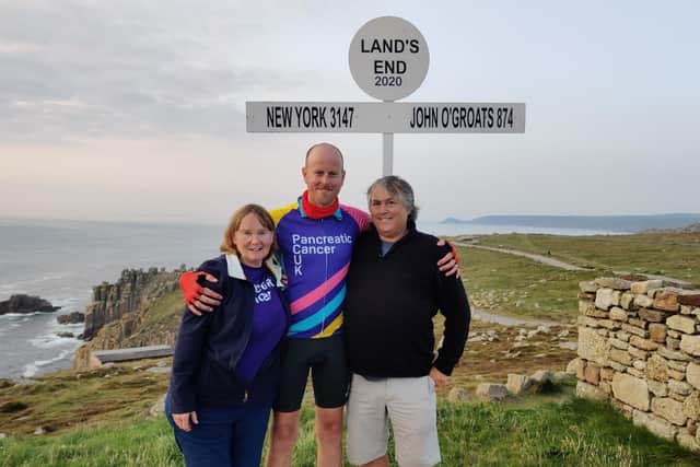 Pete Bullock is congratulated at the end of his team's epic cycle fundraiser by the parents of his late friend, Paul Huddlestone, Gwyn and Phil EMN-200910-102948001