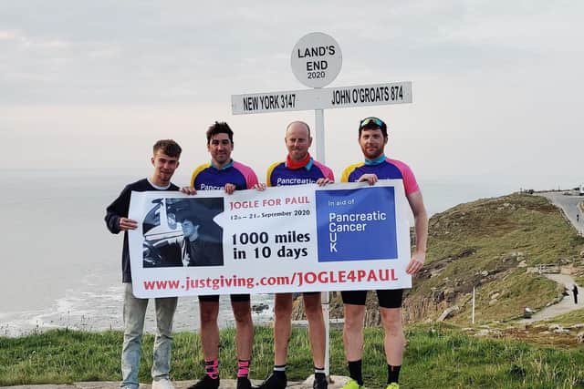 Pete Bullock (second from right) with his cycle challenge team mates, from left, Chris Nattras, Phil Muff and Andrew Robertson, at the finish at Land's End EMN-200910-105654001