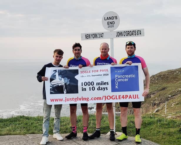 Pete Bullock (second from right) with his cycle challenge team mates, from left, Chris Nattras, Phil Muff and Andrew Robertson, at the finish at Land's End EMN-200910-105654001