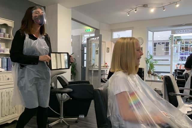 Abigail Eaves who has raised money for the Little Princess Trust by having her long hair cut pictured with stylist Lisa at Elliott Hair Design, on Church street EMN-200311-110751001