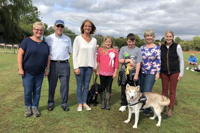 (From left to right): Old Dalby Day two years ago - Sharon Barber, Barry Lewell, Sarah Moulds and daughter with reserve best in show working spaniel Brior, Alison Clarke with winner of best in show husky Honey, Lynne Marshall and Kate Warren Price PHOTO: Supplied EMN-201011-112728001