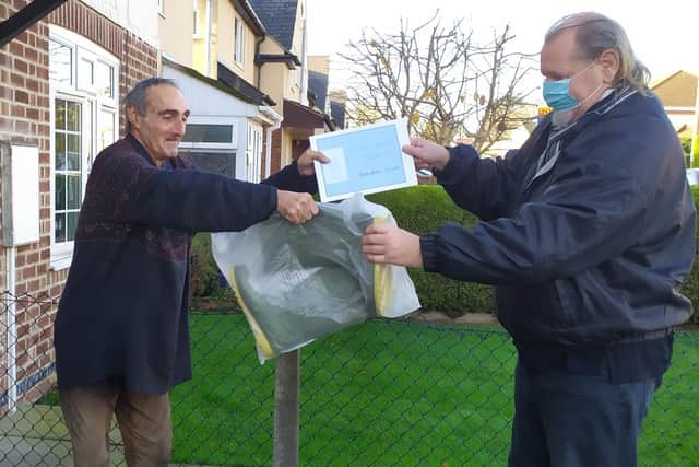 Unsung hero Alan Whitfield is presented with a framed certificate from Melton Matters and a pair of donated wellies from Councillor Alan Pearson EMN-201124-120220001