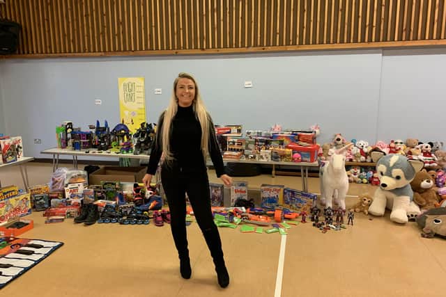 Melton mum Lisa Godber in the hall at The Grove Primary School with some of the hundreds of donated toys she has collected for struggling local families EMN-201214-125531001