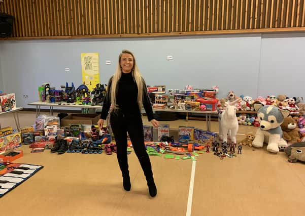 Melton mum Lisa Godber in the hall at The Grove Primary School with some of the hundreds of donated toys she has collected for struggling local families EMN-201214-125531001