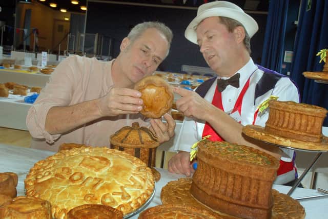 TV chef Phil Vickery (left) inspects the pork pies with Stephen Hallam, of Melton's Dickinson and Morris Ye Olde Pork Pie Shoppe, at the judging for the 2017 British Pie Awards EMN-201222-081309001