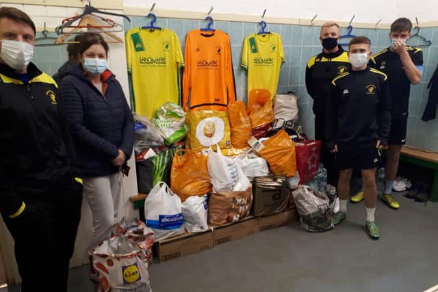 Players at Holwell Sports FC with Sharon Brown and donations collected by the club EMN-201223-172319001