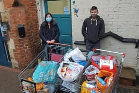 Shane Taylor-Beeby delivers 16 bags full of food and drink to Melton Storehouse manager Caroline Stannard EMN-201223-172247001