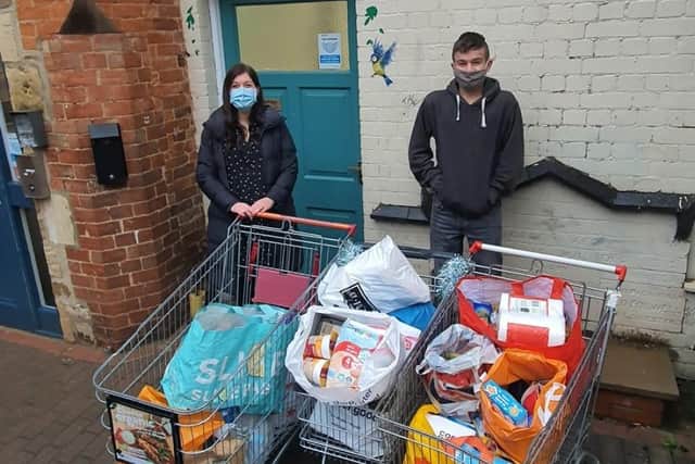 Shane Taylor-Beeby delivers 16 bags full of food and drink to Melton Storehouse manager Caroline Stannard EMN-201223-172247001