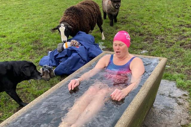 Justine Sore braves near freezing temperatures to complete one of her fundraising dips in an animal water trough at her Melton farm EMN-210114-164318001