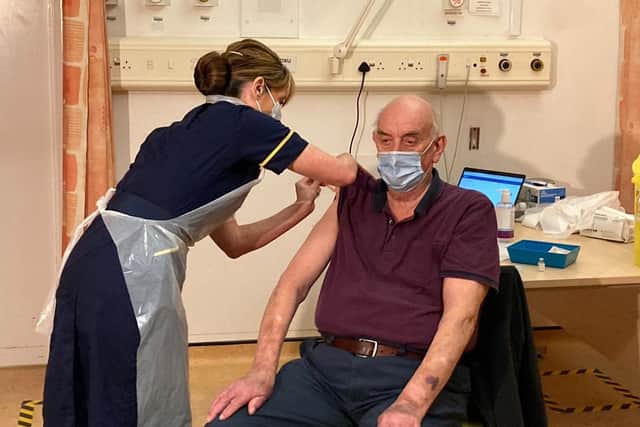82-year-old Brian Pinker was the first person in the world to receive the new Oxford AstraZeneca vaccine from nurse Sam Foster at Oxford's Churchill Hospital EMN-210122-175922001