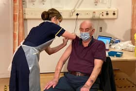82-year-old Brian Pinker was the first person in the world to receive the new Oxford AstraZeneca vaccine from nurse Sam Foster at Oxford's Churchill Hospital EMN-210122-175922001