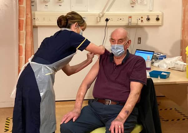82-year-old Brian Pinker was the first person in the world to receive the new Oxford AstraZeneca vaccine from nurse Sam Foster at Oxford's Churchill Hospital EMN-210122-175922001
