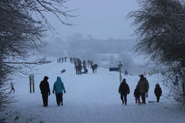 People take a walk through Melton Country Park in snowy conditions on Sunday afternoonPHOTO ROBERT CRAIG EMN-210125-100657001