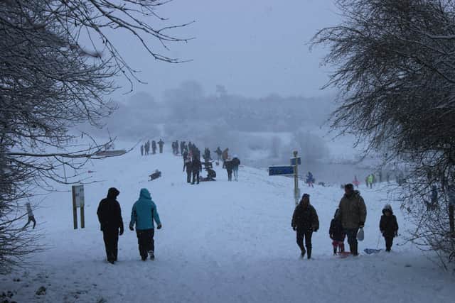 People take a walk through Melton Country Park in snowy conditions on Sunday afternoon
PHOTO ROBERT CRAIG EMN-210125-100657001