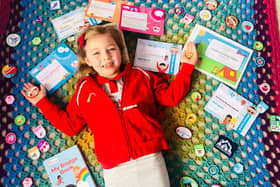 Violet Newell shows off her many badges from Asfordby 1st Rainbows EMN-210215-173006001