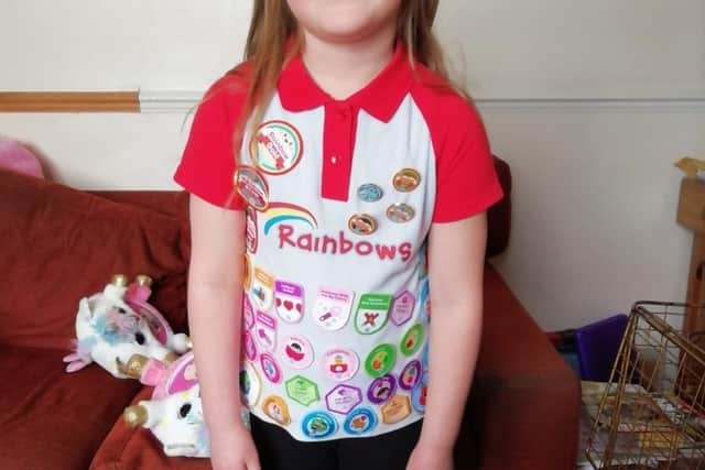Emma Coulson shows off her many badges from Asfordby 1st Rainbows EMN-210215-173016001