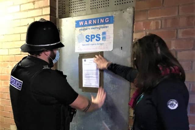 Melton police officer Pc Davey Rawlings puts up a notice to enforce a court order for the closure of 65 Rutland Street, Melton, for the next three months due to anti-social behaviour at the address EMN-210226-184126001