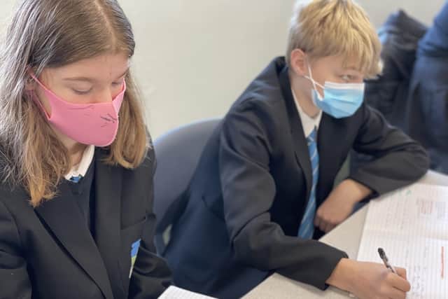 Students wearing masks in class as they returned to classrooms at Melton's Long Field Academy EMN-210317-112058001
