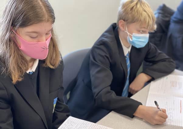 Students wearing masks in class as they returned to classrooms at Melton's Long Field Academy EMN-210317-112058001
