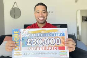 People’s Postcode Lottery ambassador Danyl Johnson with one of the £30,000 cheques won by three Melton residents EMN-210321-170744001
