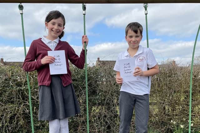 Thrussington Primary School pupils with copies of 'The Little Book of Lockdown Positivity' EMN-210323-133503001