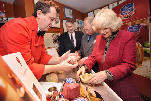 Making traditional Melton Mowbray Pork Pies during their Visit to Ye Olde Pork Pie Shoppe in Melton Mowbray... L-R Stephen Hallam, managing director of Dickinson and Morris, Brian Stein, group chief executive of Samworth Brothers, Prince Charles and the Duchess of Cornwall EMN-210325-152427001