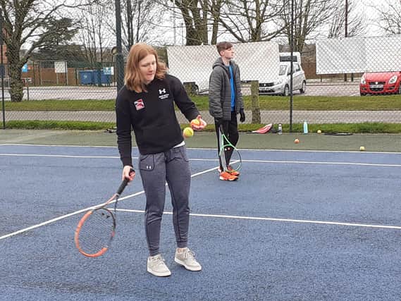 Amelia Coltman, a promising tennis player, gets back on court at Melton Sports Village to help out with junior training EMN-200503-162215002