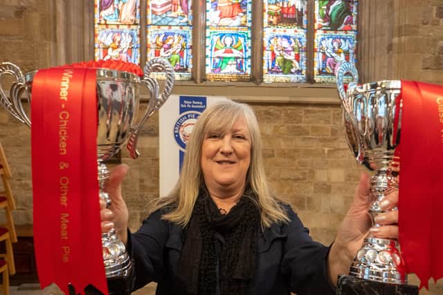 Kath Wallmsley shows off Nice Pie's trophies for two class wins at the British Pie Awards in Melton EMN-201103-103300001